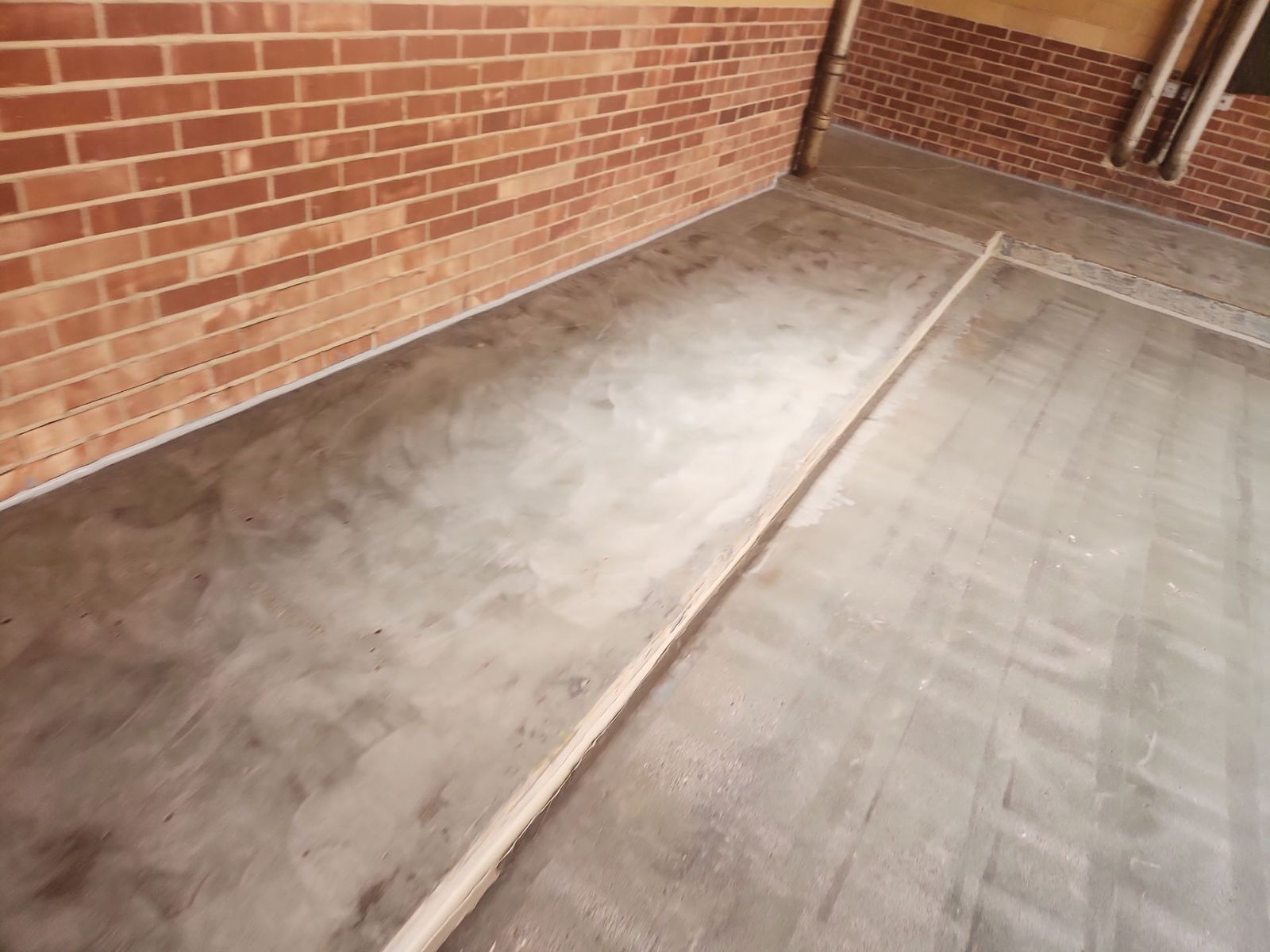 Shot blast preparation of an elevated garage slab ahead of a traffic coating system
