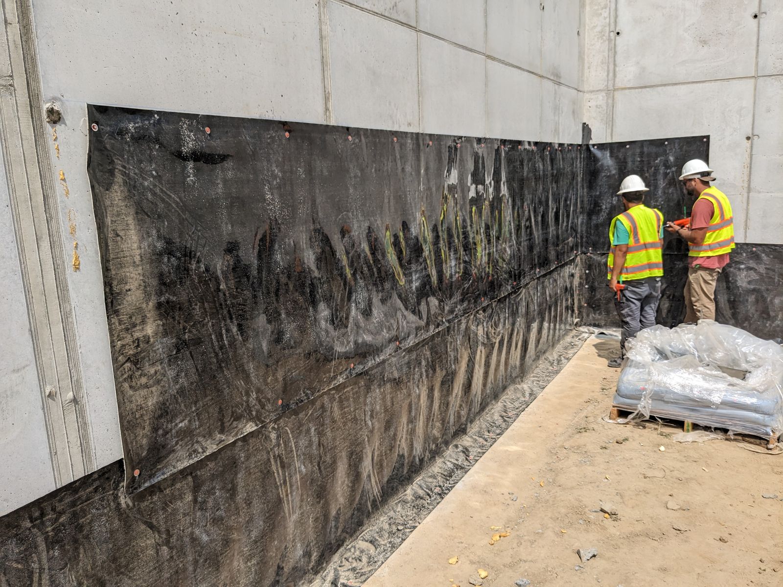 Fisher Xteriors crew working together on a foundation wall installation